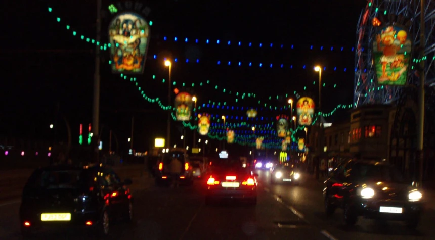 a city street with lots of lights and christmas decorations
