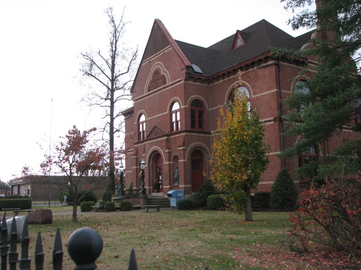 a large building with many windows next to a cemetery