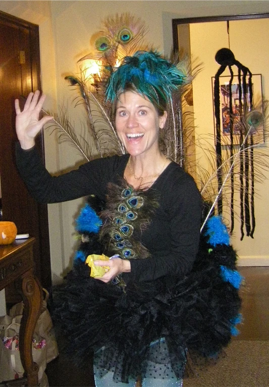 a woman with feathers around her body, and her hands in the air