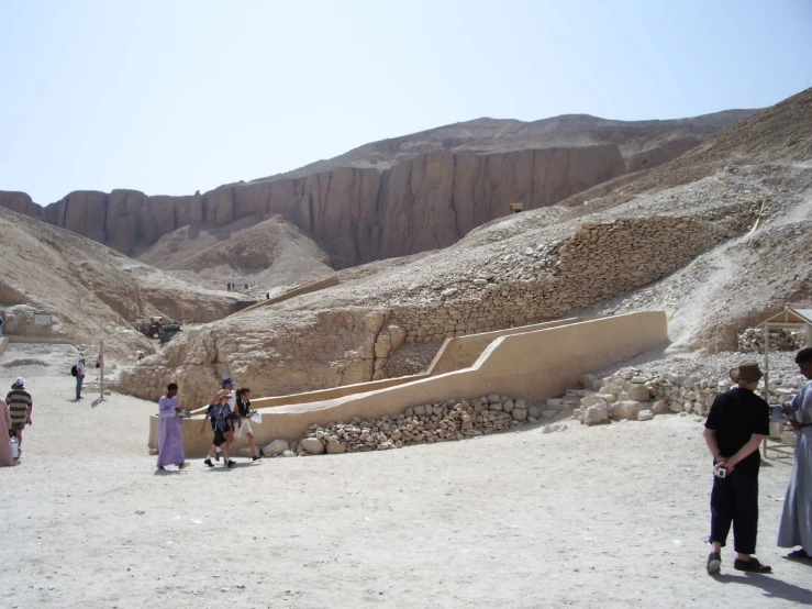 a group of people stand at an egyptian park