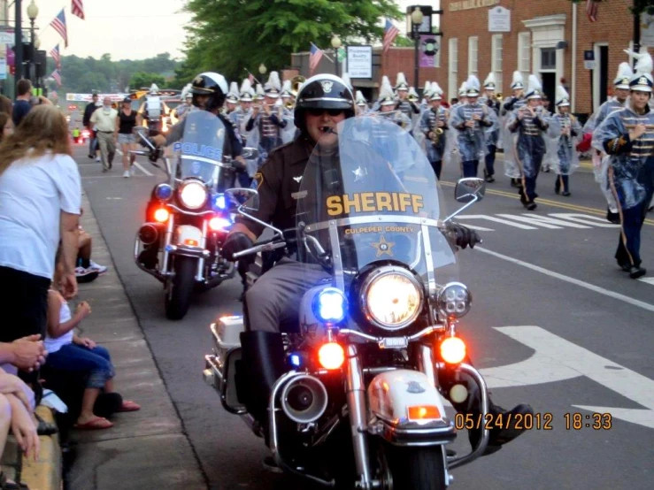 a large group of people are on motorcycles in a parade