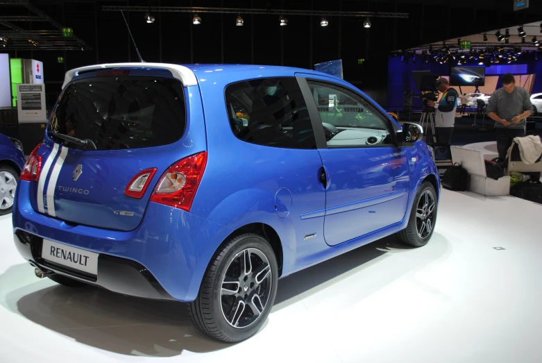 blue car at an indoor show where it is on display