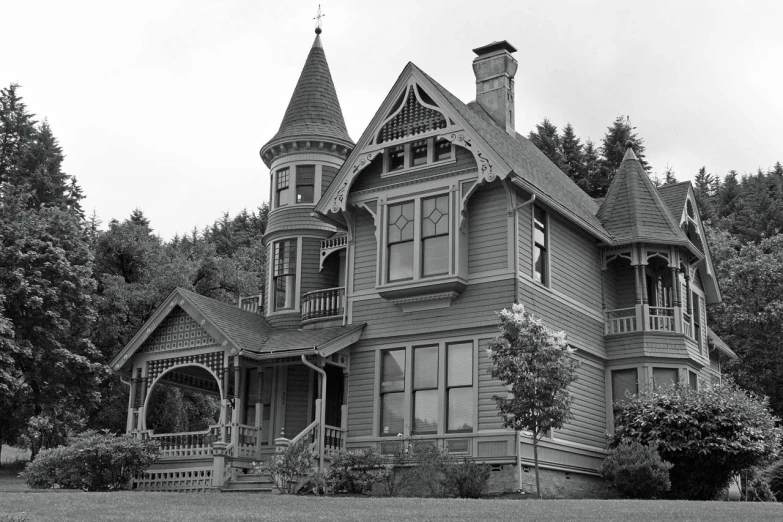 a house sitting next to a tree filled field