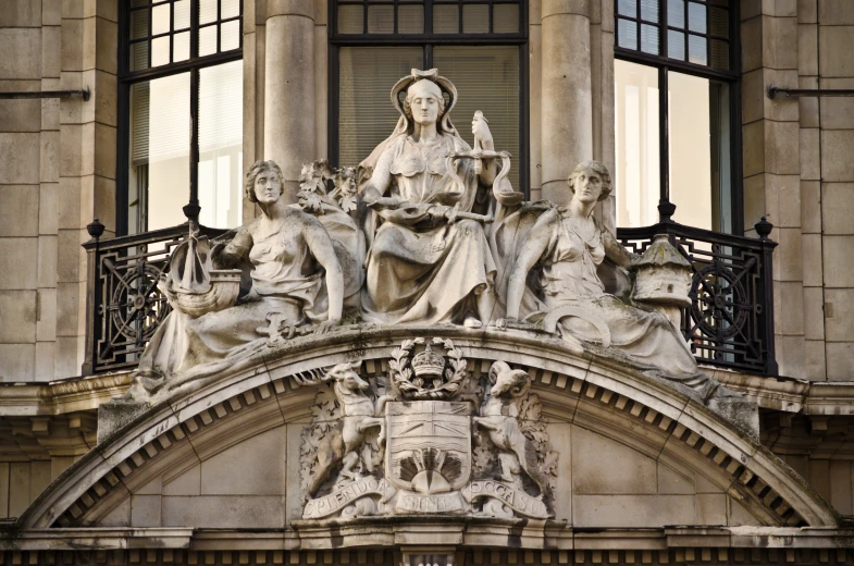 statue on side of building with open windows