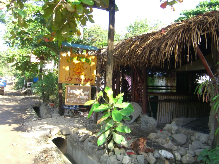 an outdoor area with small huts and rocks on the ground