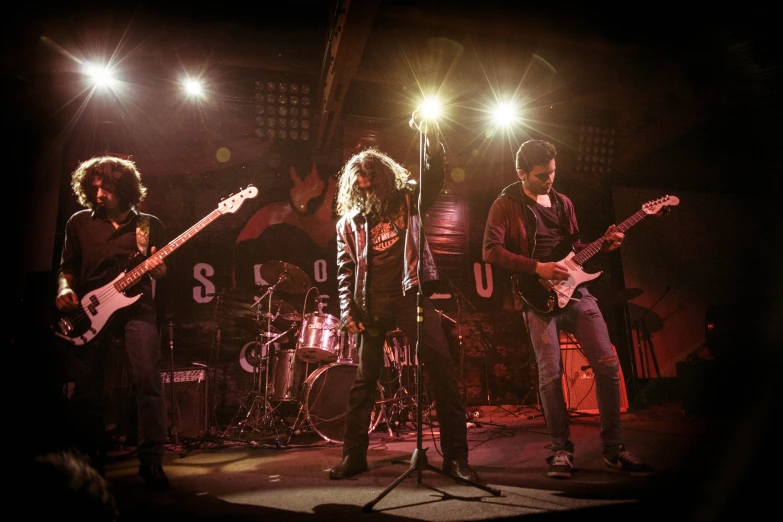 a group of people on a stage with guitars