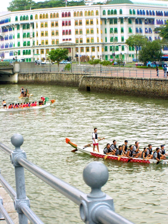 some people are rowing in a boat on the water