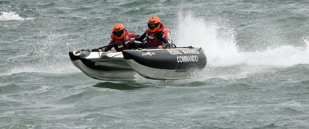 two men riding a small boat through the water