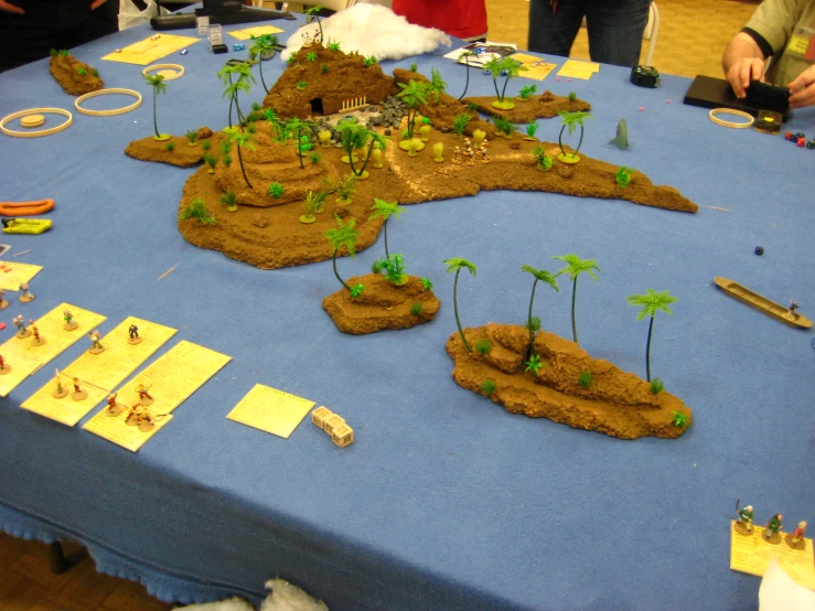 a blue table topped with a large desert covered in dirt