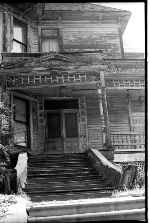 an old, dilapidated house in the midst of winter