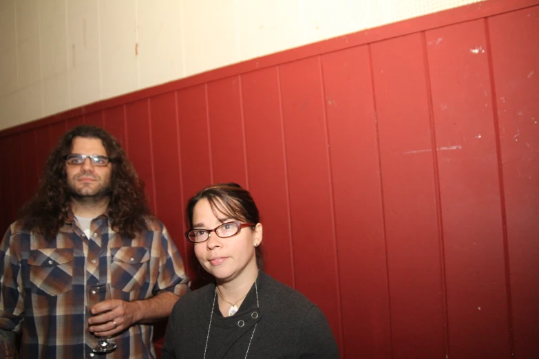 two men posing for the camera wearing checkered shirts