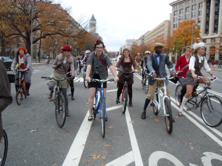 a group of people riding bicycles through a crosswalk