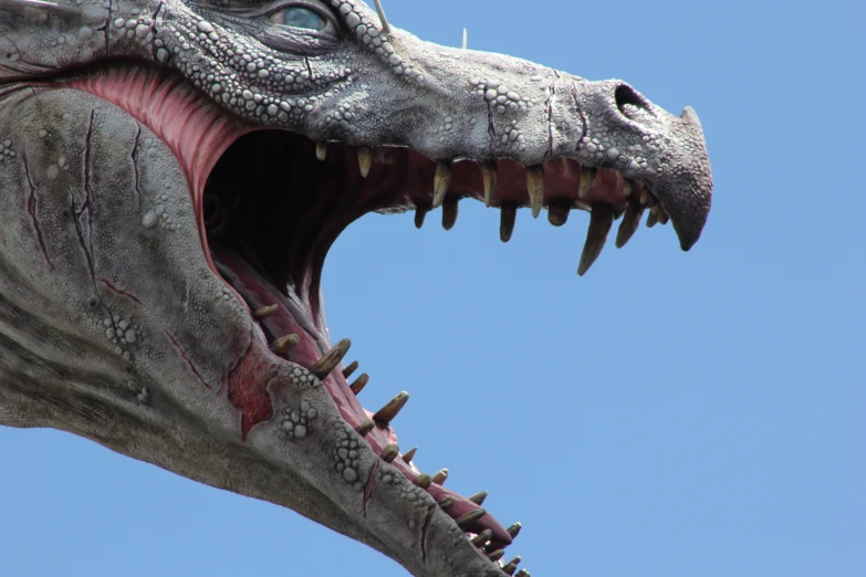 a close up of a large dinosaur statue on display