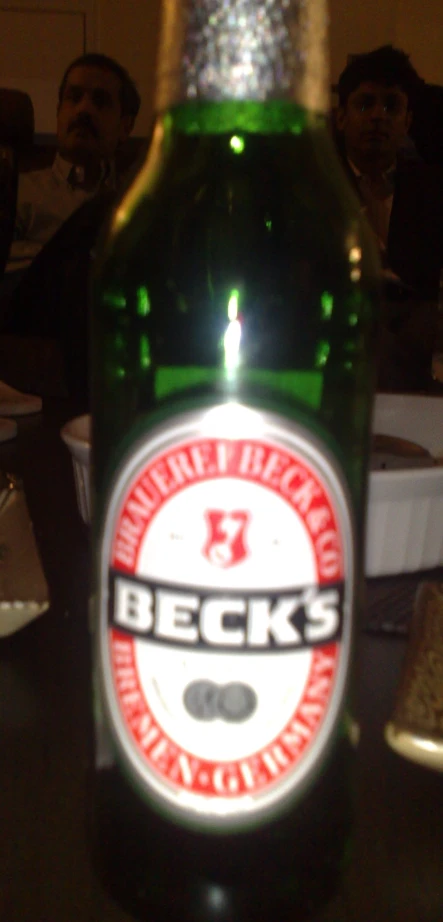 a bottle of beer is shown in front of a table