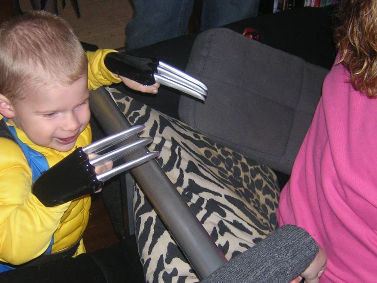 a little boy with some hair brushes in his hand