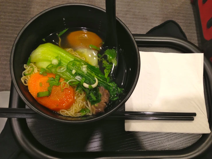 a bowl of stir fried noodles and vegetables