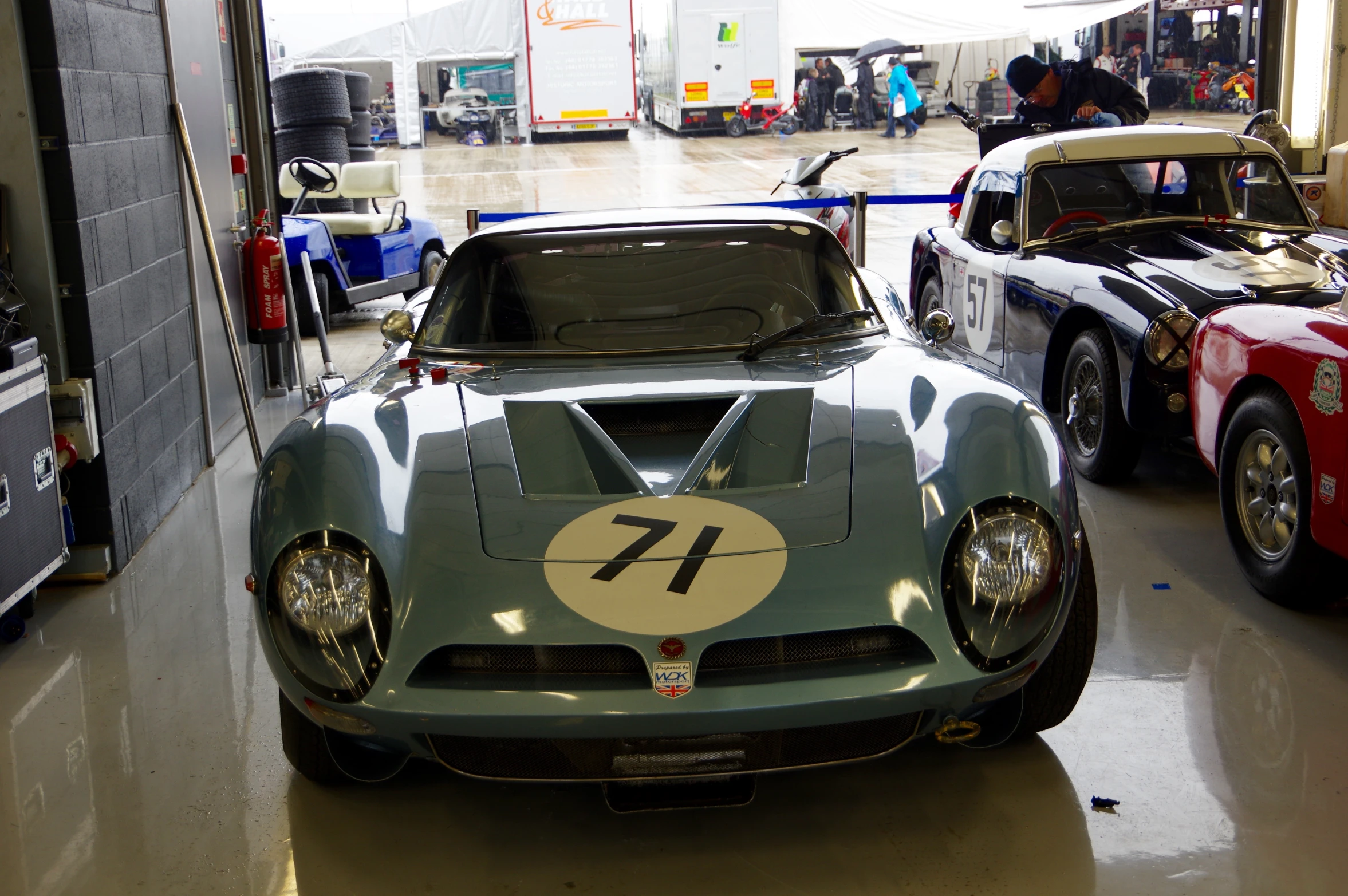 two race cars are shown parked inside the garage