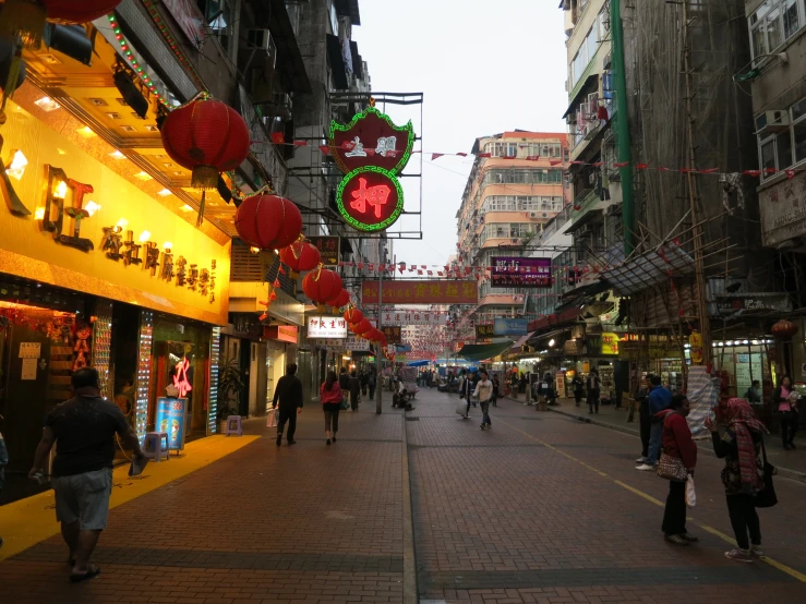 a group of people walking down a city street