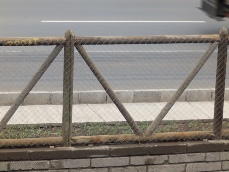 an empty parking lot with two broken fence