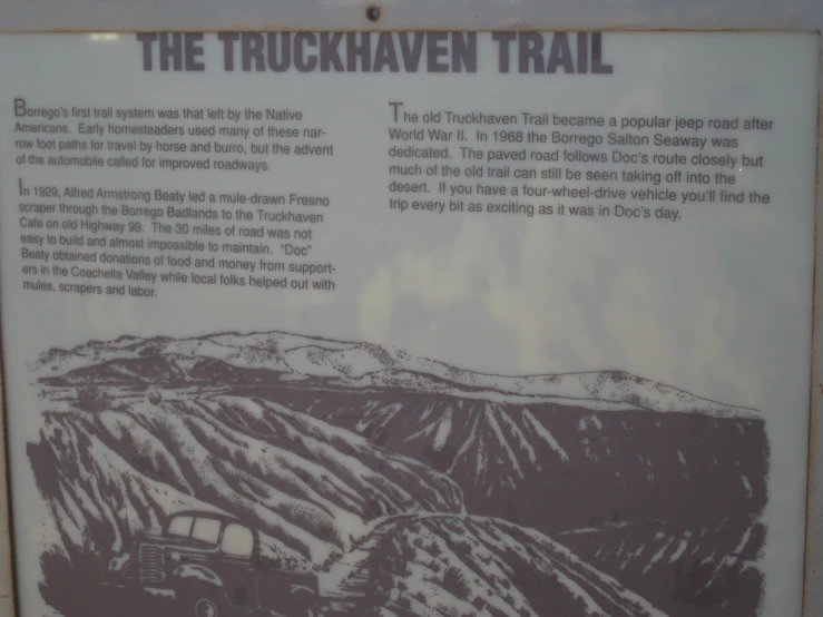 a sign describing the trail direction in which there is a vehicle