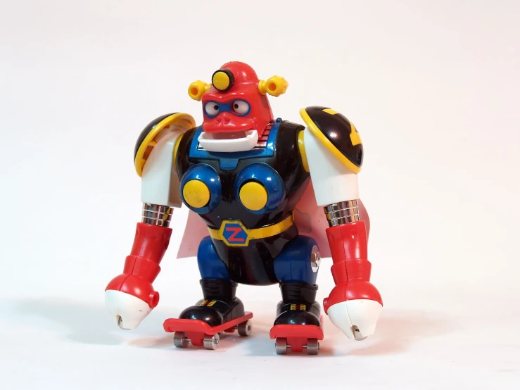 a red and blue robot with wheels and yellow arms
