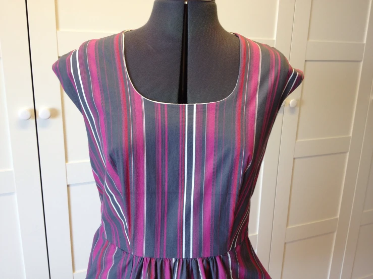 an old striped dress has pink stripes