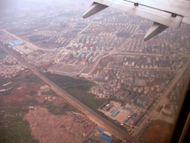 an airplane flying above the ground with the windows