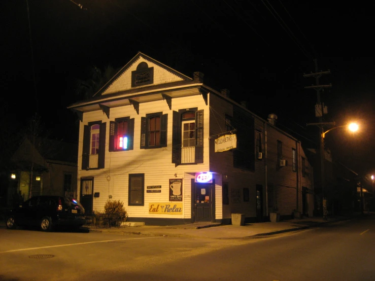 street view of a lit up traffic signal at night