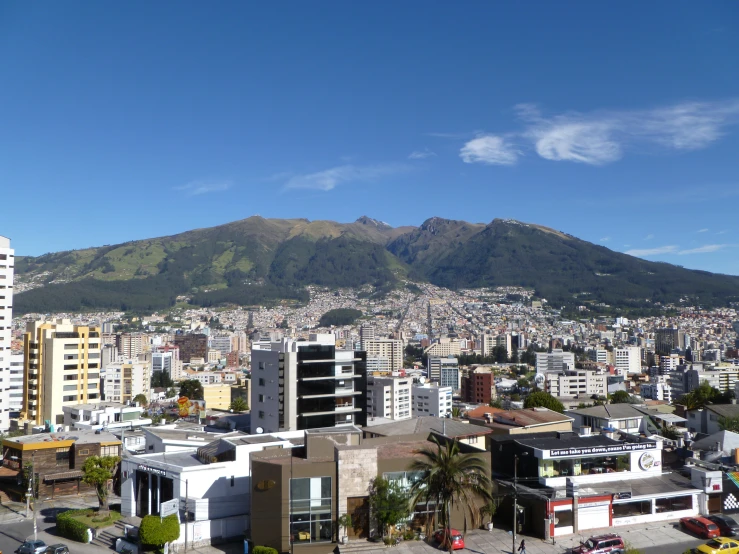 an aerial view of a city with mountains in the background