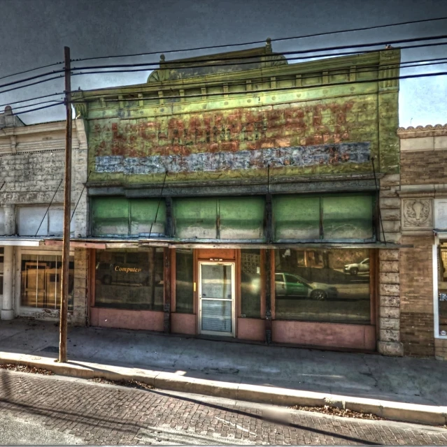 a dilapidated looking building next to a train tracks