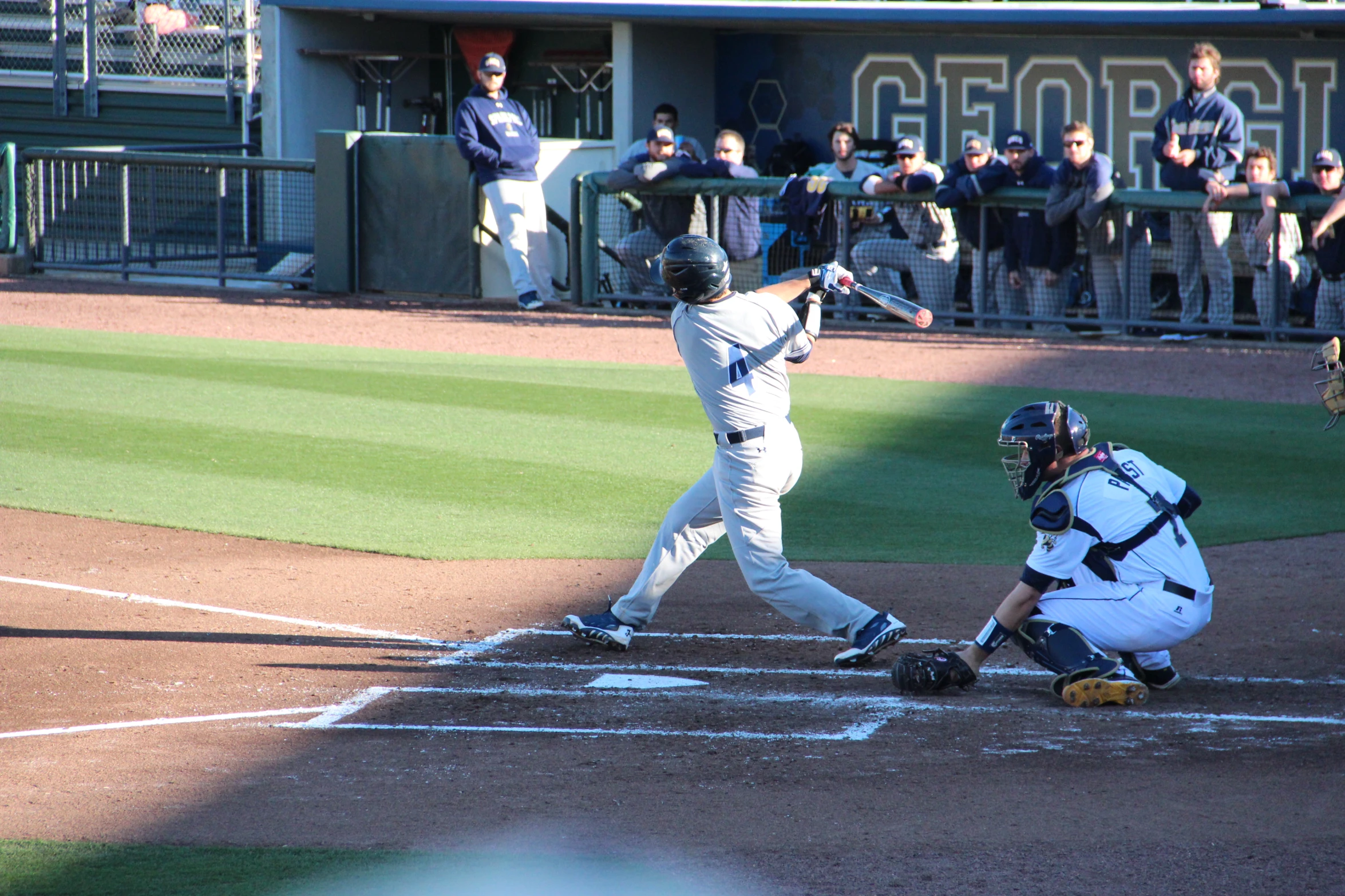 a baseball player swinging a bat on top of a field