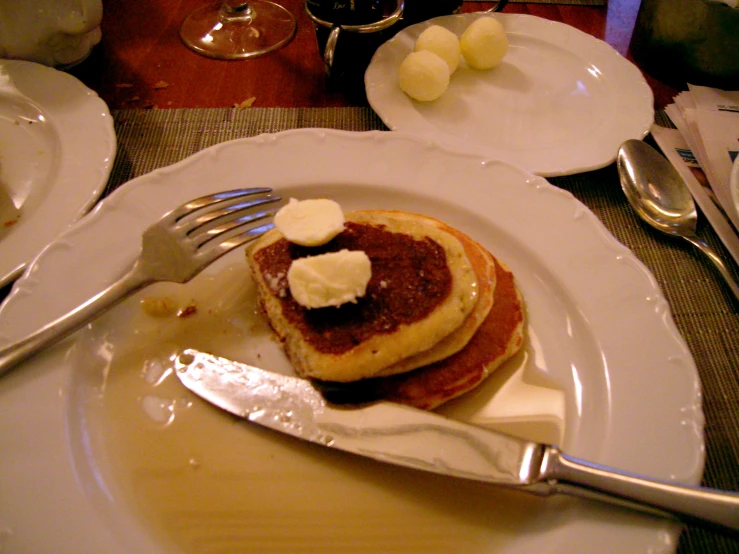 a stack of pancakes topped with er and syrup