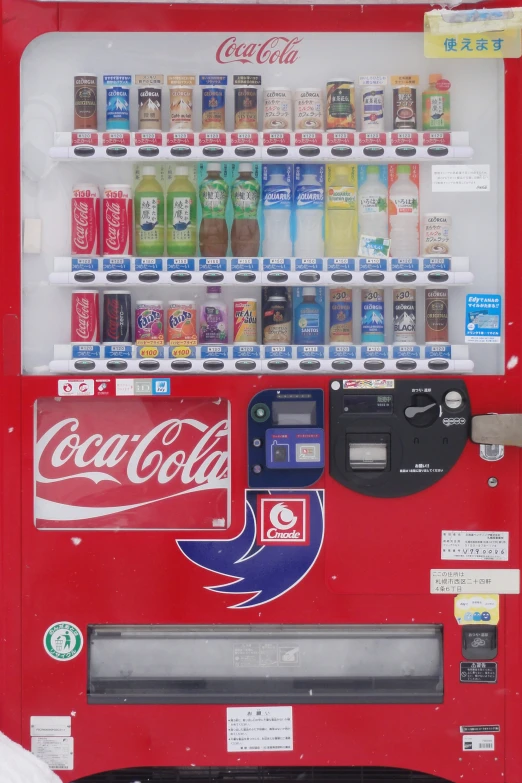 an old red coca cola machine with bottles of soda behind it