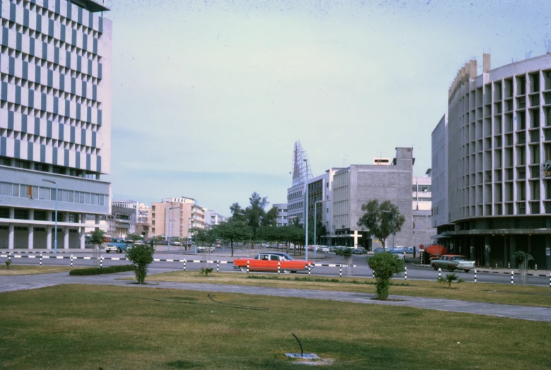 a red and white vehicle in a city with tall buildings