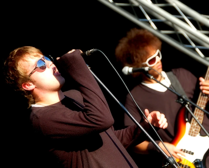 two men playing music while wearing sunglasses