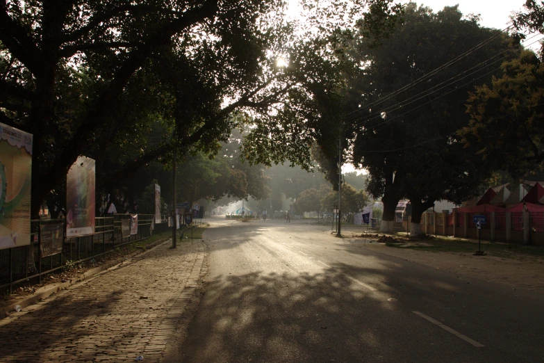 a street with parked cars and people on it