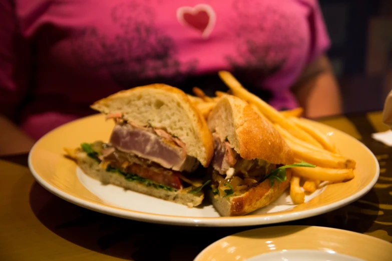 a big plate with some food and some french fries