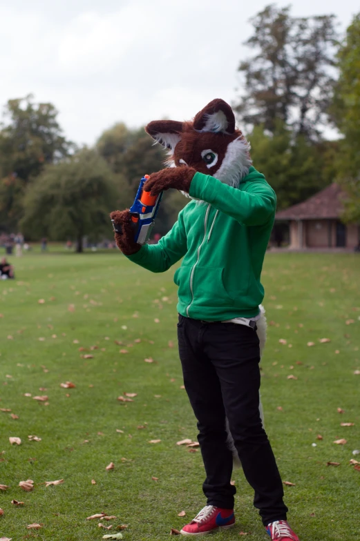 person wearing an animal costume holding a bottle