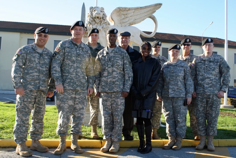 people standing in uniform pose for a po