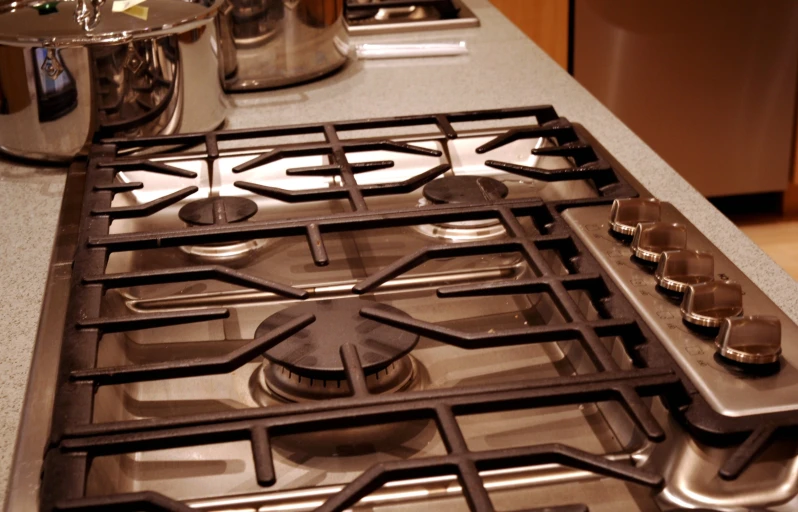 a stove top with s and a pan on it