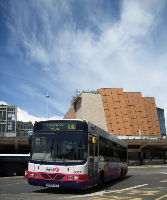 a bus parked outside a large building in front of it