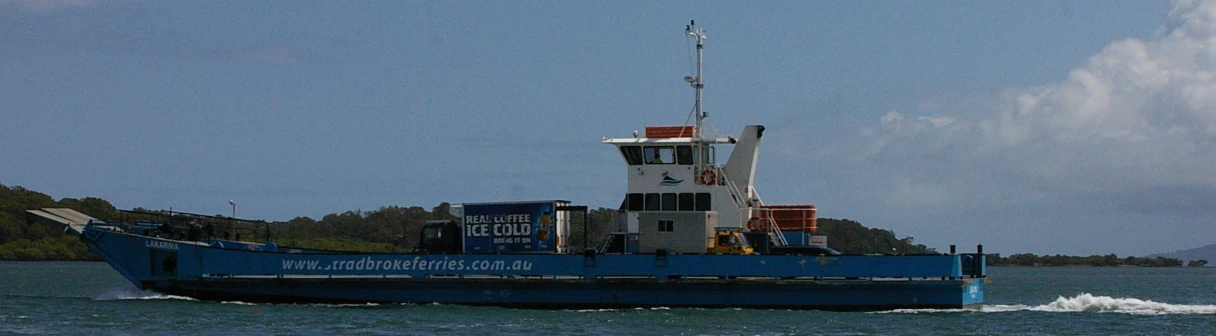 the blue boat is leaving the water by shore