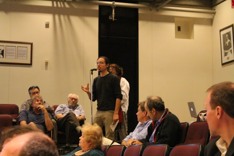 a man giving a talk in front of an audience