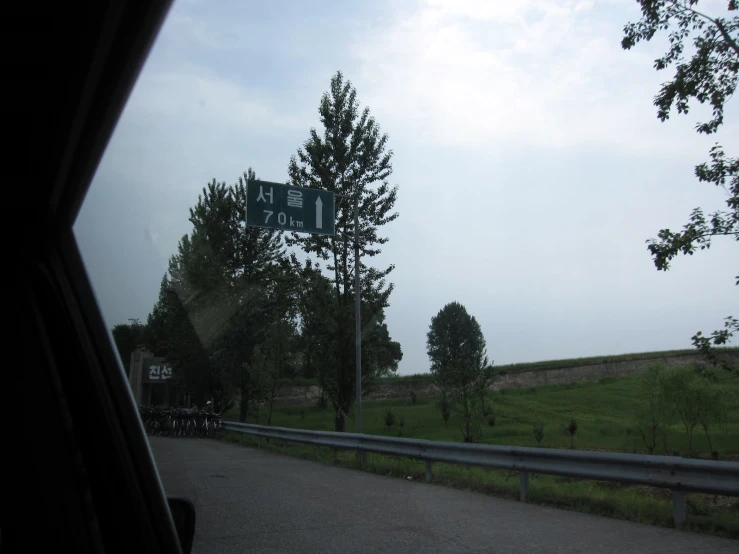 street sign along a country road on a foggy day