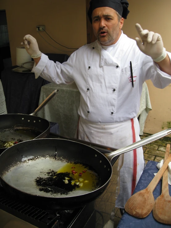 a chef with a cast iron frying pan with food on it