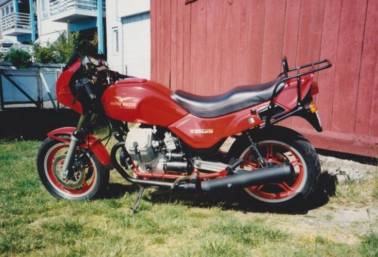 a motorcycle parked outside a building on a green grass field