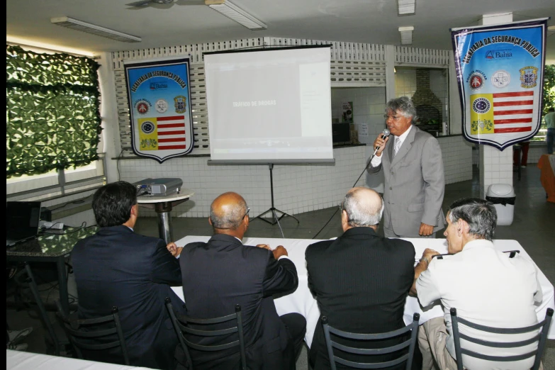 a man is giving a speech to an audience