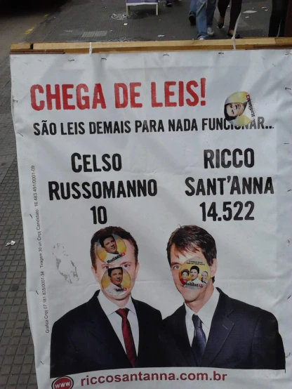 a poster with the political message and two men's faces