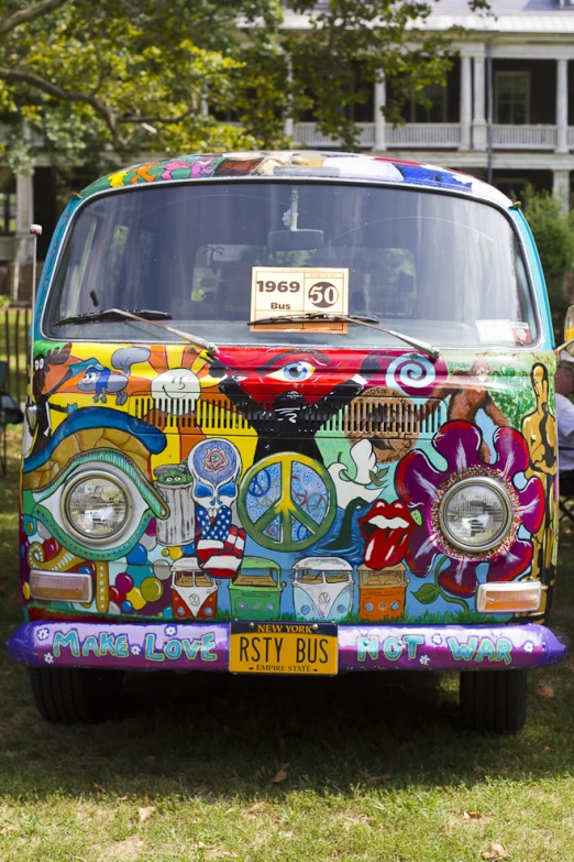 a colorful bus is parked in the grass