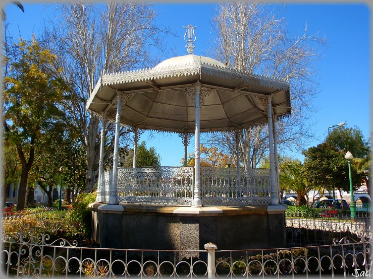 a white park type structure sitting in a park